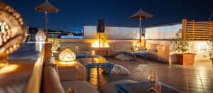 Camel Rooftop Bar relaxing low seating area at night.