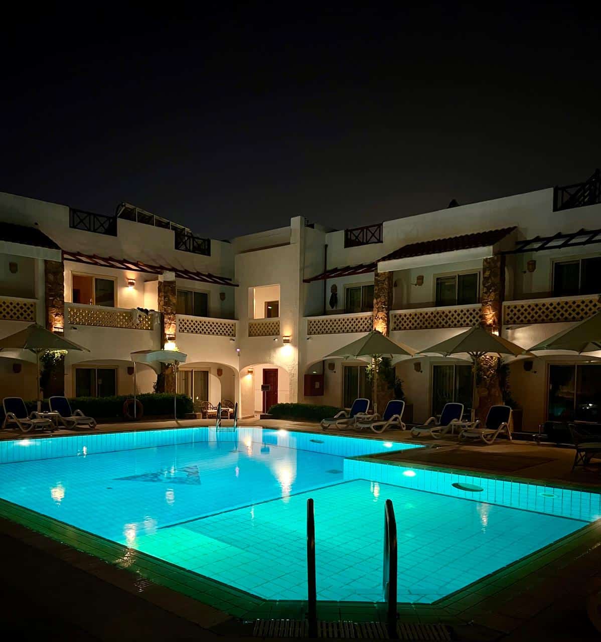 Night time view of the custom dive pool and Camel hotel (the pool is lit)